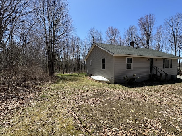 76 Norton Hill Rd, Dover-Foxcroft, ME 04426 - view of property exterior featuring roof with shingles, a chimney, and entry steps