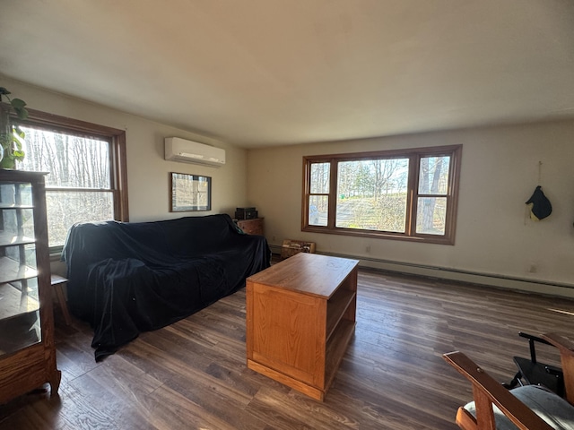 76 Norton Hill Rd, Dover-Foxcroft, ME 04426 - living area with dark wood finished floors, a wall mounted AC, and baseboard heating