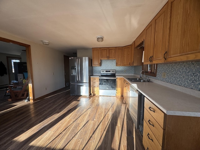 76 Norton Hill Rd, Dover-Foxcroft, ME 04426 - kitchen featuring brown cabinetry, dark wood finished floors, a sink, light countertops, and stainless steel appliances