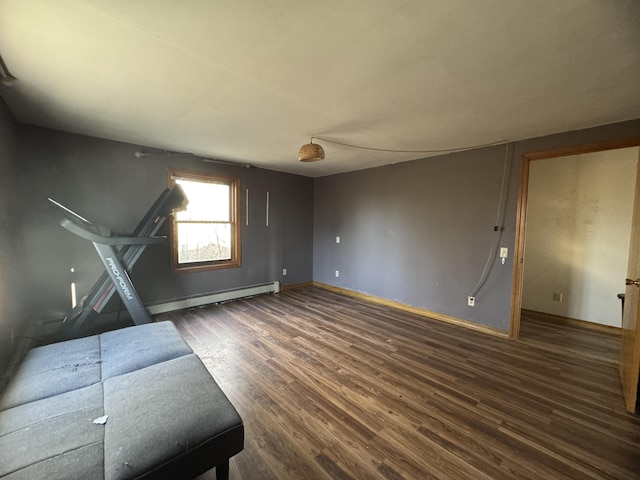 76 Norton Hill Rd, Dover-Foxcroft, ME 04426 - unfurnished living room featuring wood finished floors, baseboards, and a baseboard heating unit