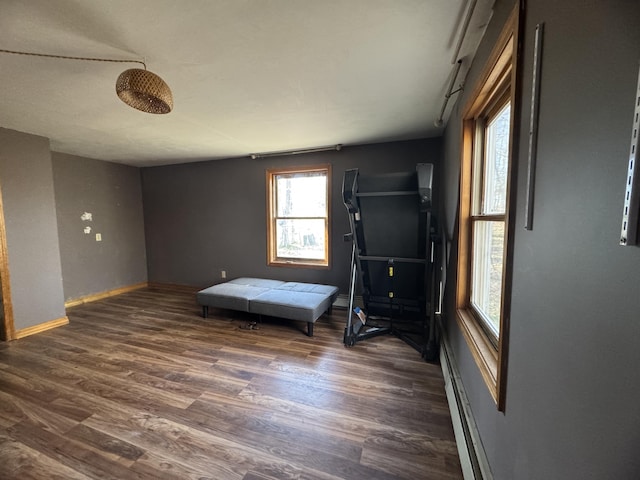 76 Norton Hill Rd, Dover-Foxcroft, ME 04426 - living area featuring baseboards, dark wood-style flooring, and a baseboard heating unit