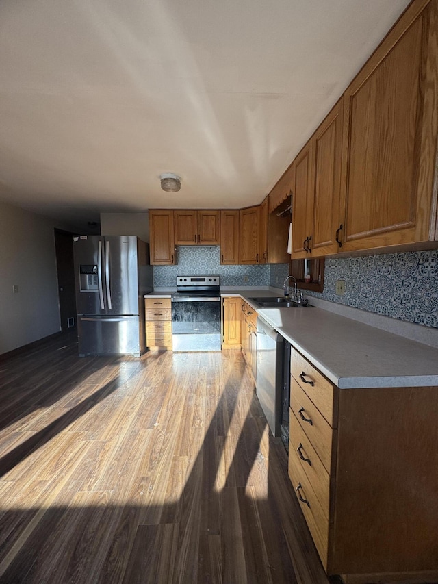 76 Norton Hill Rd, Dover-Foxcroft, ME 04426 - kitchen with a sink, dark wood-style flooring, brown cabinets, and stainless steel appliances