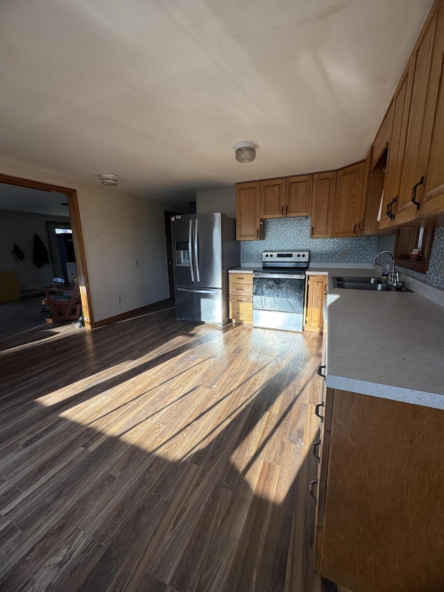 76 Norton Hill Rd, Dover-Foxcroft, ME 04426 - kitchen with a sink, appliances with stainless steel finishes, brown cabinets, and dark wood-type flooring