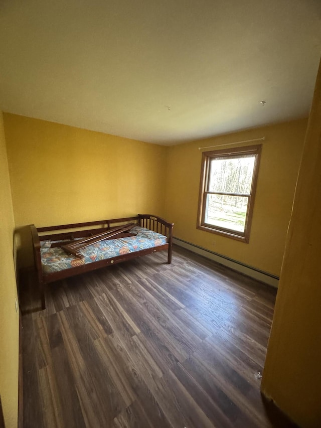 76 Norton Hill Rd, Dover-Foxcroft, ME 04426 - bedroom with wood finished floors and a baseboard heating unit