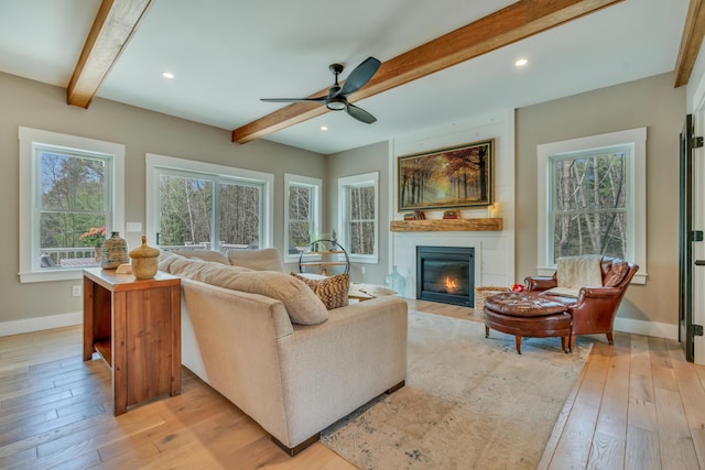 27 Oak Ridge Ter, Arundel, ME 04046 - living room featuring light wood-type flooring, a large fireplace, beam ceiling, ceiling fan, and baseboards