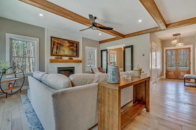 27 Oak Ridge Ter, Arundel, ME 04046 - living room with beamed ceiling, baseboards, french doors, a ceiling fan, and light wood-type flooring