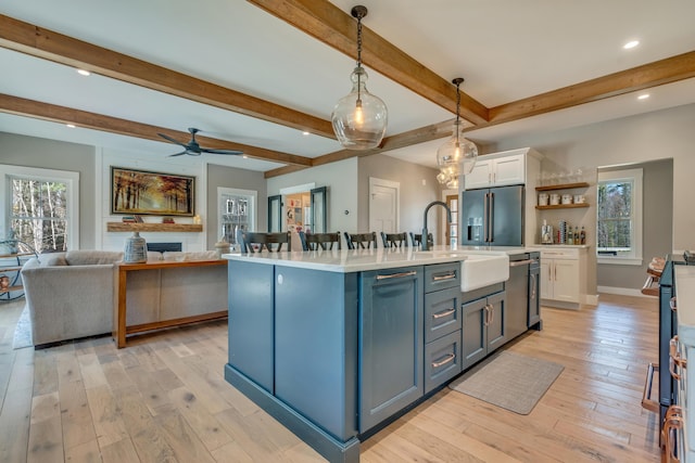 27 Oak Ridge Ter, Arundel, ME 04046 - kitchen featuring stainless steel appliances, a sink, white cabinets, light countertops, and light wood-type flooring