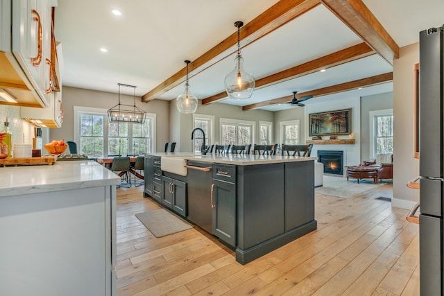 27 Oak Ridge Ter, Arundel, ME 04046 - kitchen with a sink, dishwasher, a large fireplace, light wood-type flooring, and ceiling fan