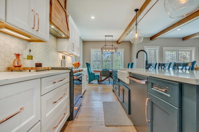 27 Oak Ridge Ter, Arundel, ME 04046 - kitchen with appliances with stainless steel finishes, white cabinetry, a sink, tasteful backsplash, and healthy amount of natural light
