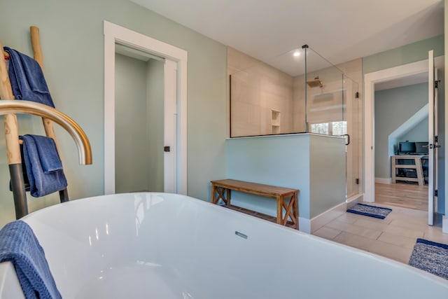 27 Oak Ridge Ter, Arundel, ME 04046 - bathroom featuring a stall shower, a freestanding tub, and baseboards