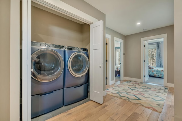 27 Oak Ridge Ter, Arundel, ME 04046 - laundry room with wood finished floors, washer and dryer, baseboards, and recessed lighting
