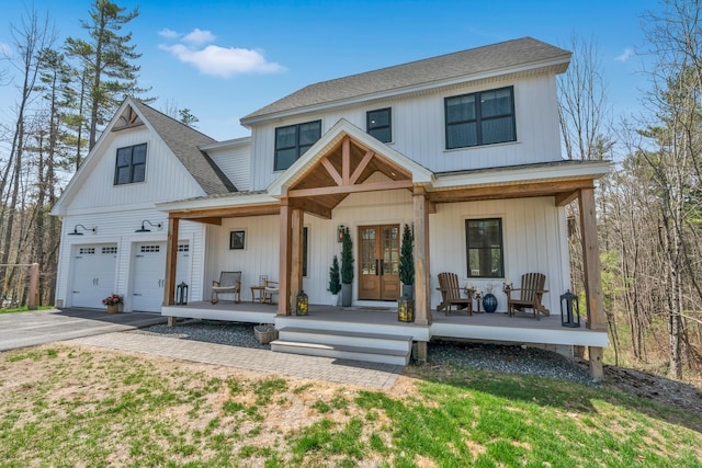 27 Oak Ridge Ter, Arundel, ME 04046 - modern farmhouse style home featuring a porch, driveway, and roof with shingles