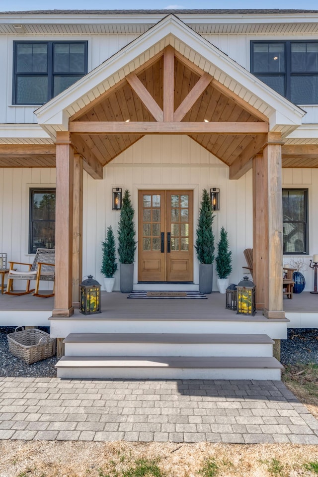 27 Oak Ridge Ter, Arundel, ME 04046 - property entrance featuring french doors, a porch, and board and batten siding