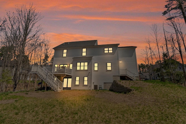 27 Oak Ridge Ter, Arundel, ME 04046 - back of property with stairs, a deck, a lawn, and central air condition unit