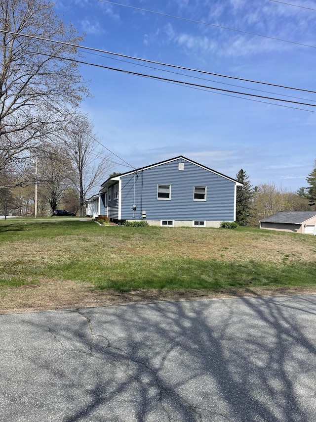 view of side of property featuring a yard