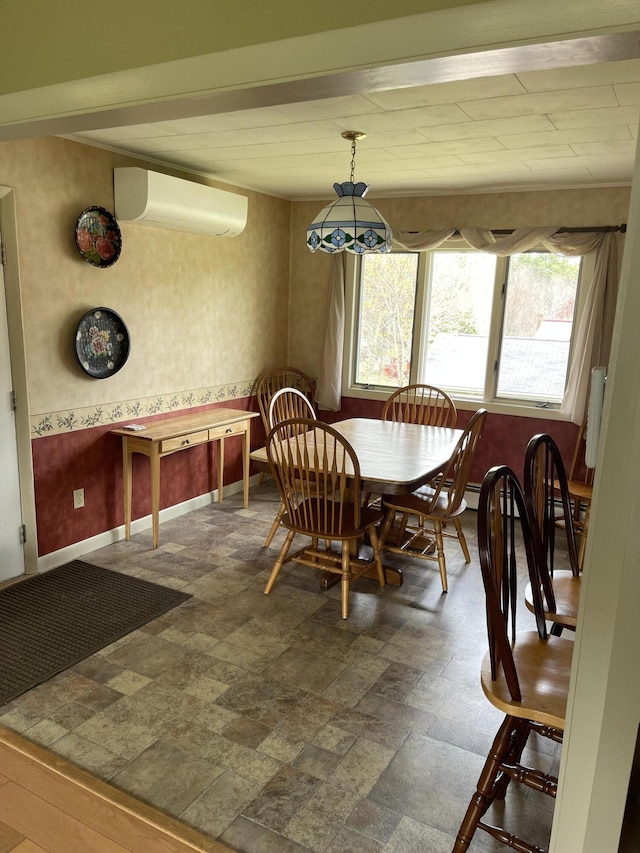dining area featuring a wall mounted AC, baseboards, and a wealth of natural light