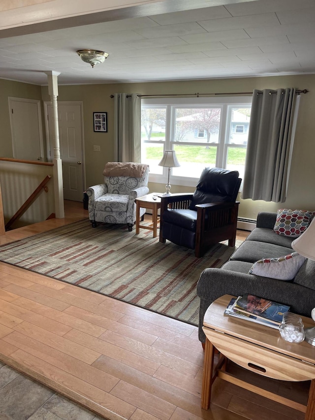living room with wood finished floors and a baseboard radiator