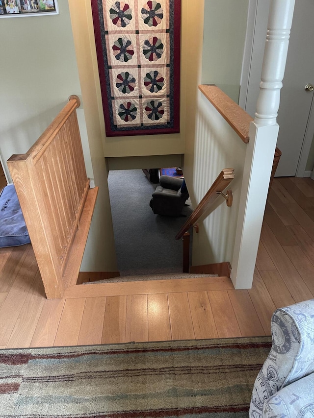 stairway with wood finished floors