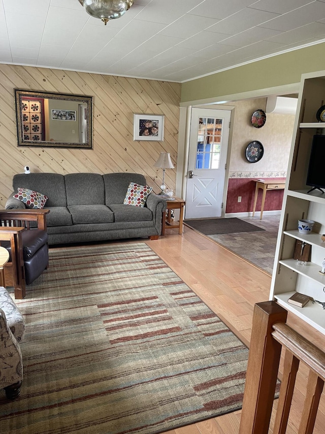 living area with wooden walls and wood finished floors