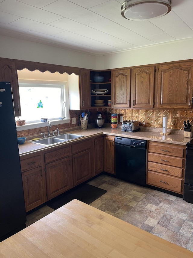 kitchen featuring a sink, open shelves, black appliances, light countertops, and tasteful backsplash