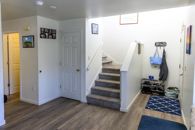 stairs featuring baseboards and wood finished floors