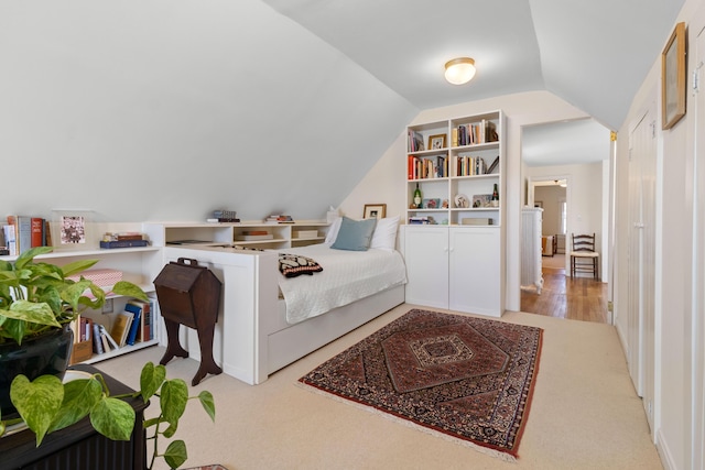 carpeted bedroom with vaulted ceiling