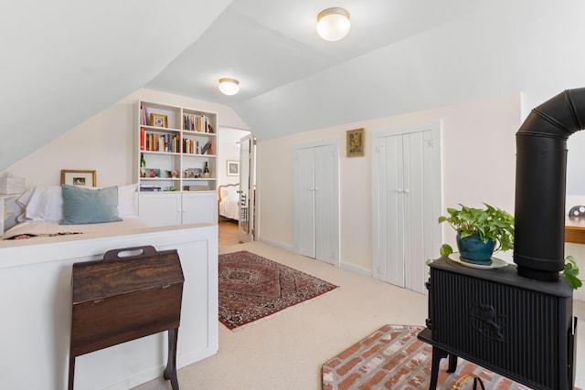 bedroom featuring vaulted ceiling and light carpet