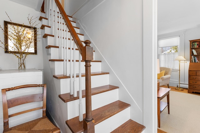 stairs featuring baseboard heating