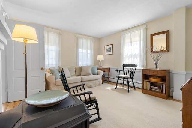 living room with plenty of natural light and a baseboard radiator