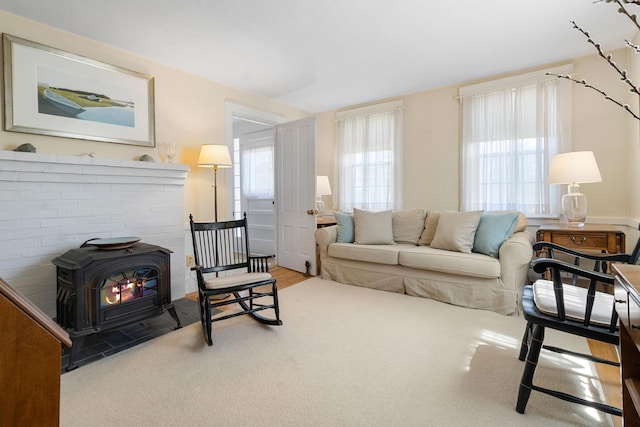 living area with carpet floors and a wood stove