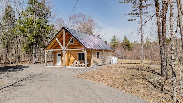 view of front of house featuring covered porch and metal roof