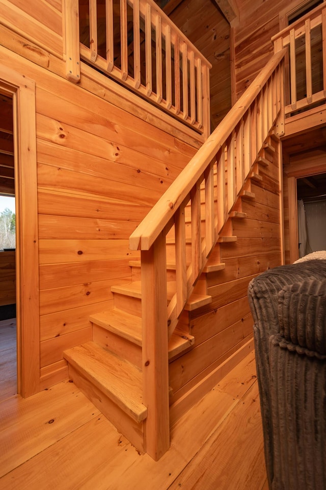 stairs featuring wooden walls, hardwood / wood-style flooring, and a sauna