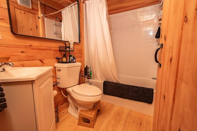 full bath featuring visible vents, wood finished floors, vanity, toilet, and shower / bathtub combination with curtain