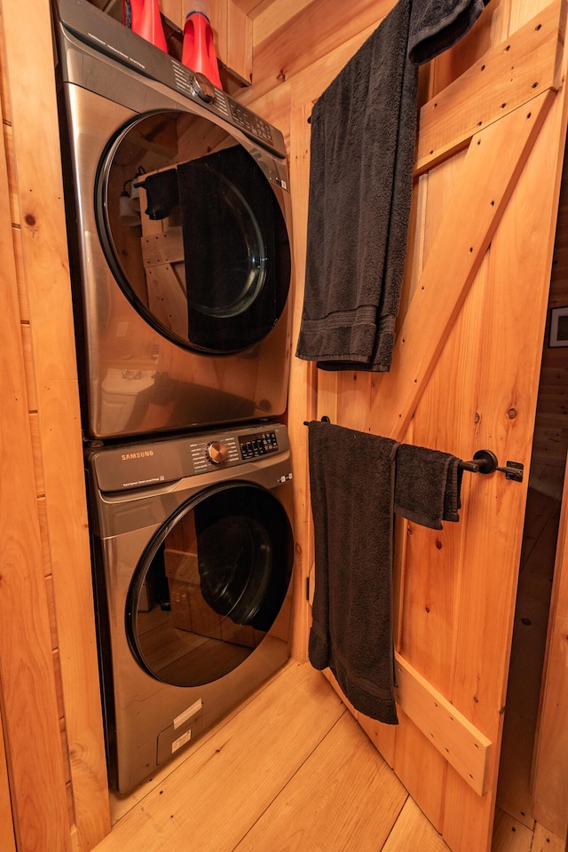 washroom with stacked washer / drying machine and laundry area