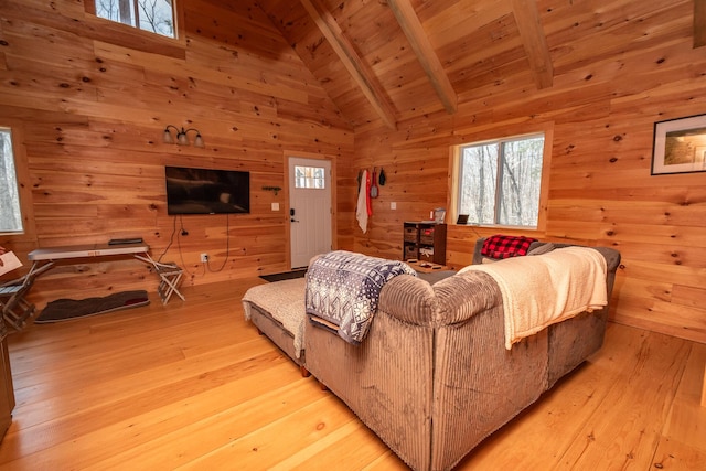 living area featuring wood walls, beam ceiling, wooden ceiling, high vaulted ceiling, and light wood-style flooring