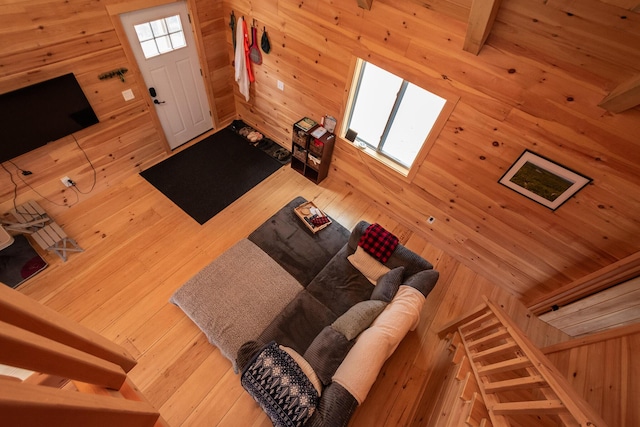 living area with hardwood / wood-style flooring and wood walls