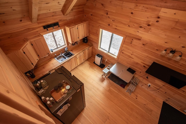 living room with beamed ceiling, wood walls, wooden ceiling, and light wood-style flooring