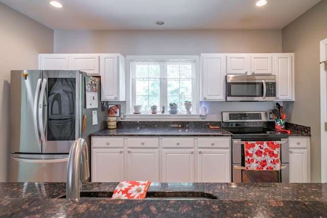 43 Sylvan Way Unit 10, Wells, ME 04090 - kitchen with appliances with stainless steel finishes, white cabinets, dark stone counters, and recessed lighting