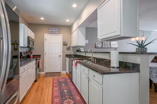 43 Sylvan Way Unit 10, Wells, ME 04090 - kitchen featuring stainless steel appliances, a sink, white cabinets, light wood-style flooring, and recessed lighting