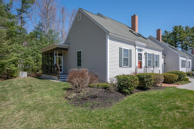 43 Sylvan Way Unit 10, Wells, ME 04090 - view of side of property with a lawn and a chimney
