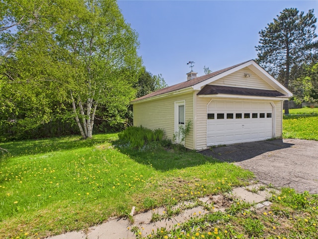 80 Garden Cir, Caribou, ME 04736 - view of side of property featuring a garage, an outbuilding, a chimney, and a lawn
