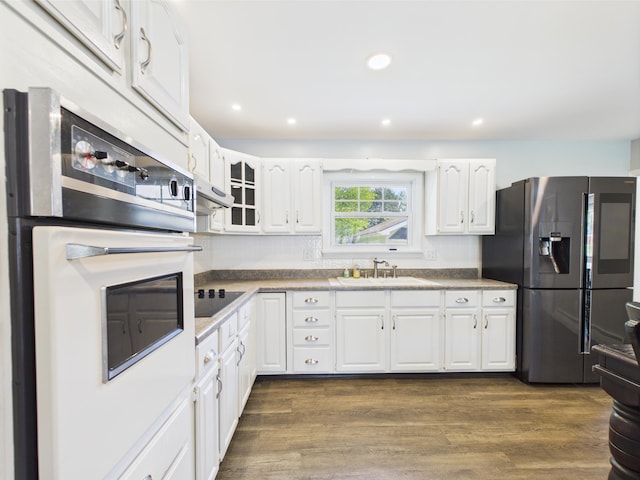 80 Garden Cir, Caribou, ME 04736 - kitchen featuring a sink, stainless steel fridge with ice dispenser, oven, black electric cooktop, and white cabinets