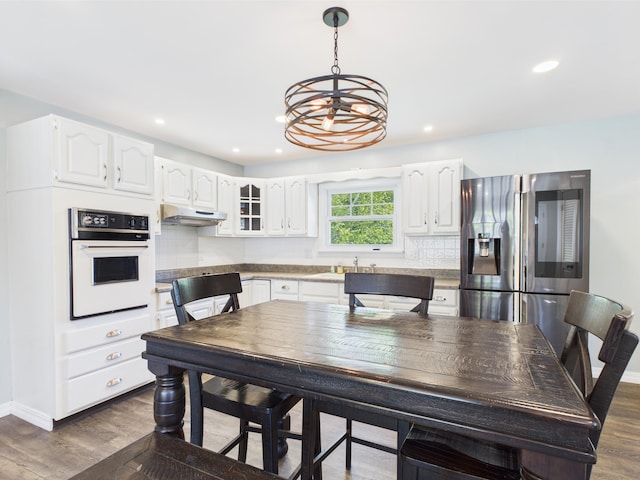 80 Garden Cir, Caribou, ME 04736 - kitchen featuring white oven, stainless steel fridge with ice dispenser, a chandelier, dark wood finished floors, and recessed lighting