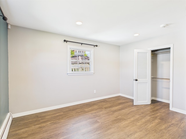 80 Garden Cir, Caribou, ME 04736 - unfurnished bedroom featuring baseboard heating, wood finished floors, baseboards, recessed lighting, and a closet
