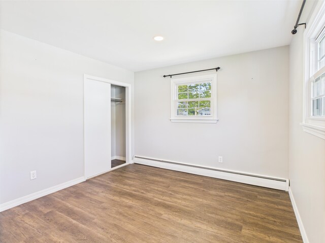 80 Garden Cir, Caribou, ME 04736 - unfurnished bedroom with a baseboard heating unit, wood finished floors, baseboards, a closet, and recessed lighting