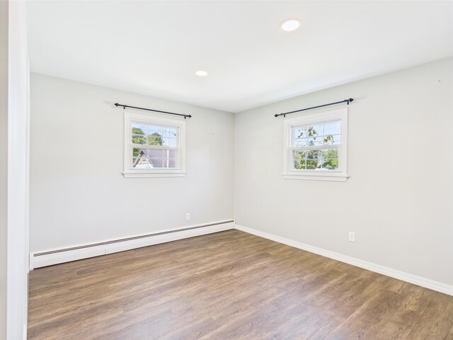 80 Garden Cir, Caribou, ME 04736 - unfurnished room with baseboard heating, wood finished floors, baseboards, and recessed lighting