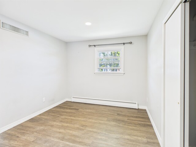 80 Garden Cir, Caribou, ME 04736 - unfurnished bedroom featuring a baseboard radiator, wood finished floors, baseboards, and recessed lighting