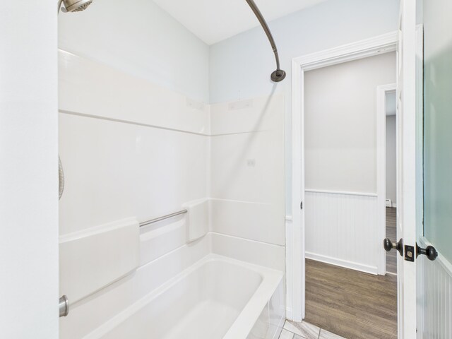 80 Garden Cir, Caribou, ME 04736 - bathroom featuring tub / shower combination, a wainscoted wall, and tile patterned floors