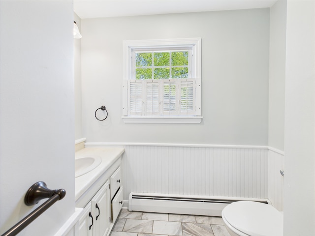 80 Garden Cir, Caribou, ME 04736 - half bathroom featuring vanity, toilet, wainscoting, and baseboard heating