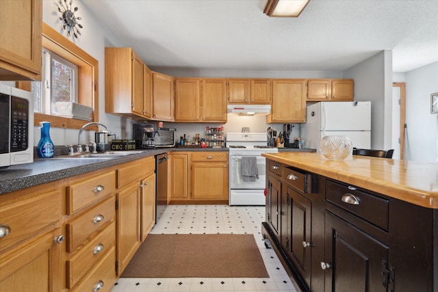 kitchen featuring white appliances, butcher block countertops, light floors, under cabinet range hood, and a sink